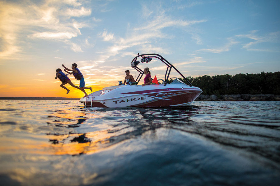 Family jumping into water from a rented boat on Table Rock Lake at Big Cedar