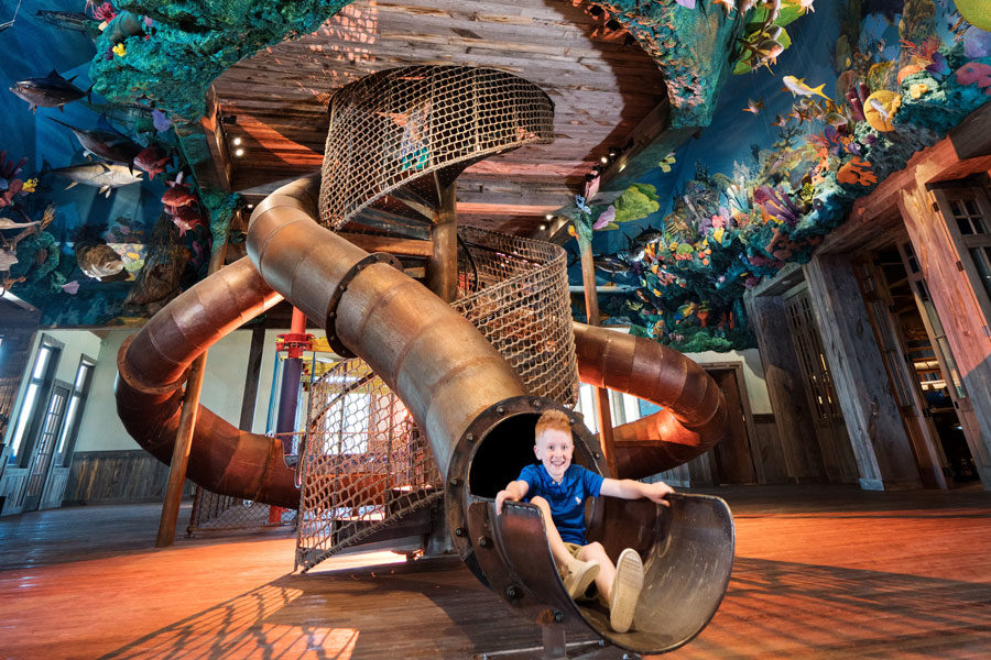 Fun Mountain climbing area at Big Cedar Kid coming out of the slide at Fun Mountain climbing area at Big Cedar