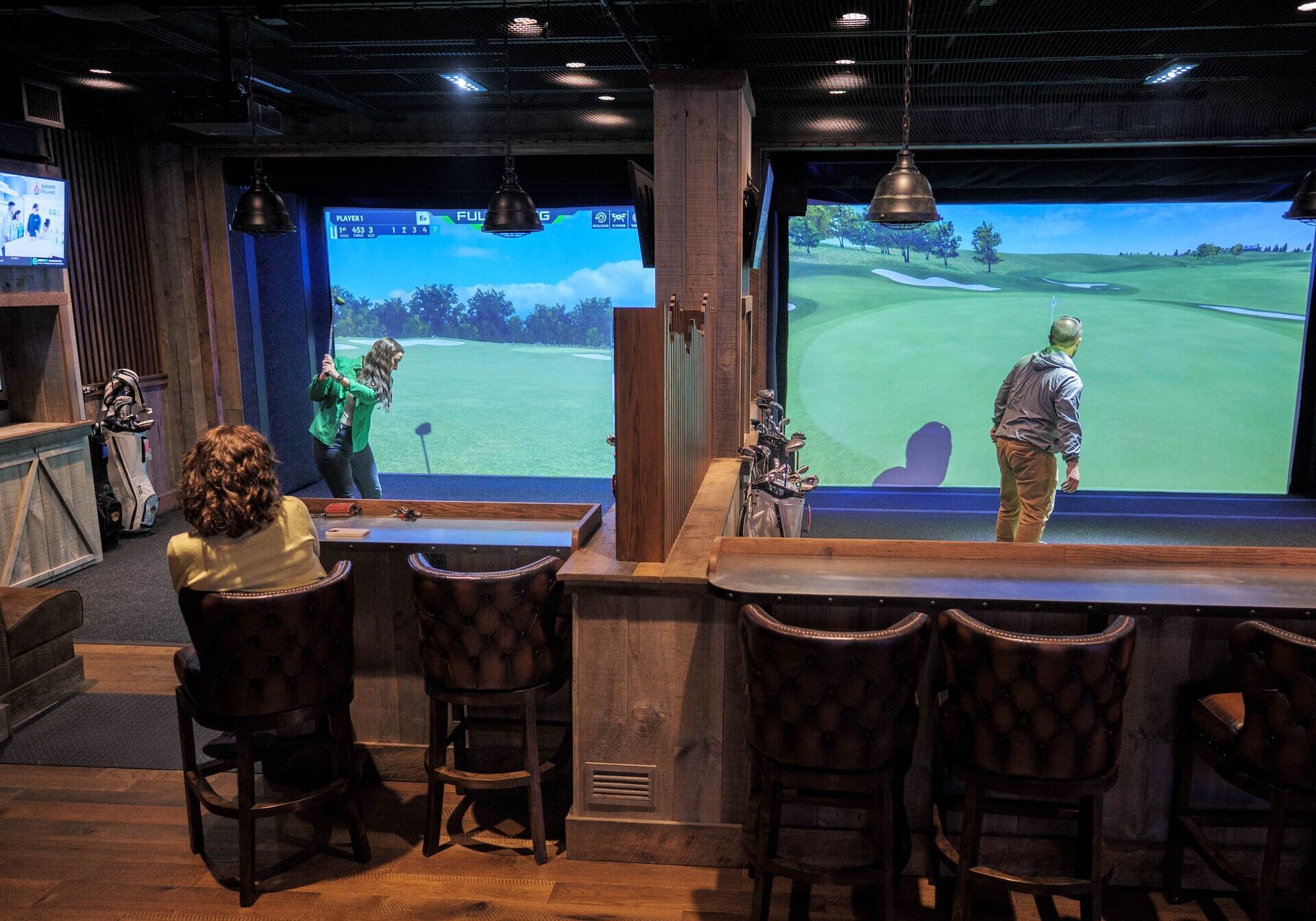 guests play the golf simulator at fun mountain