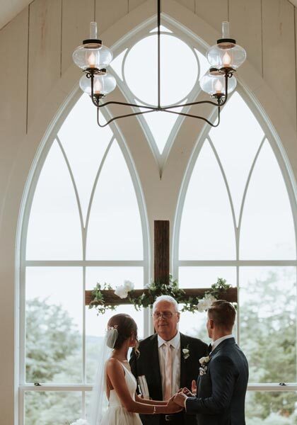 Garden Chapel at Big Cedar Couple exchanging wedding vows at the Garden Chapel at Big Cedar