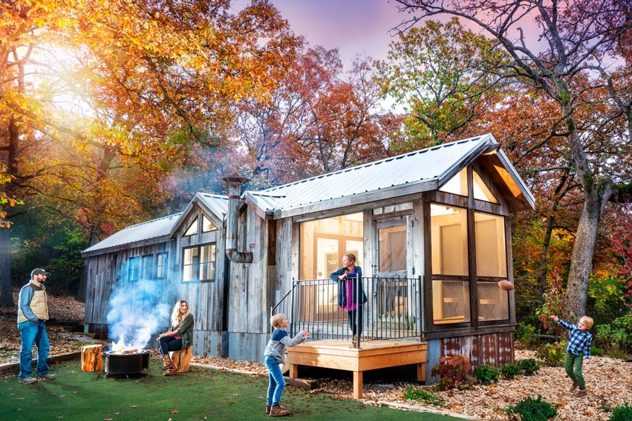Family playing outside of their Camp Cabin at Camp Long Creek while glamping at Big Cedar Lodge