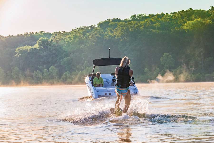 Water skiing, tubing and wakeboarding at Table Rock Lake at Big Cedar Young Woman water skiing at Table Rock Lake at Big Cedar